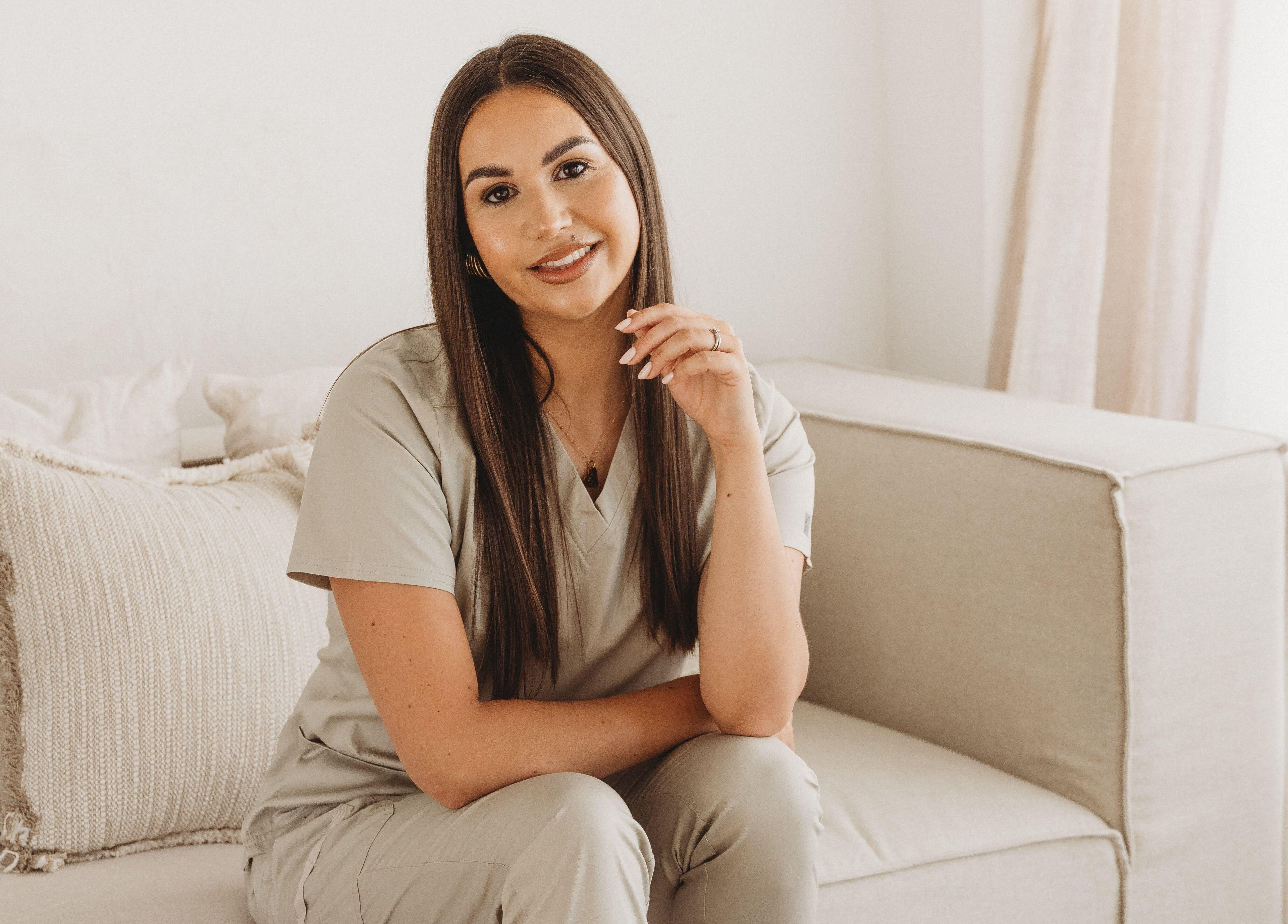 Professional at Cure The Nail Studio in Oswestry, England, GB seated in a serene, cozy setting.