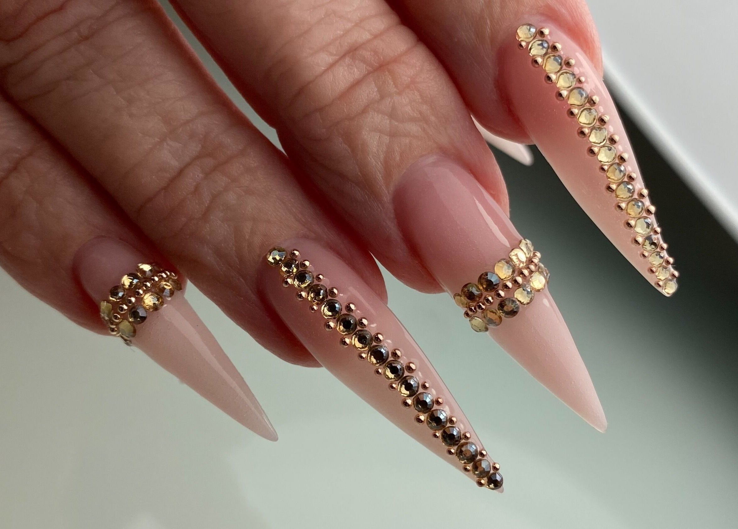 Ongles décorés avec des strass dorés à Onglerie Dynastie, Laval, Québec, CA.