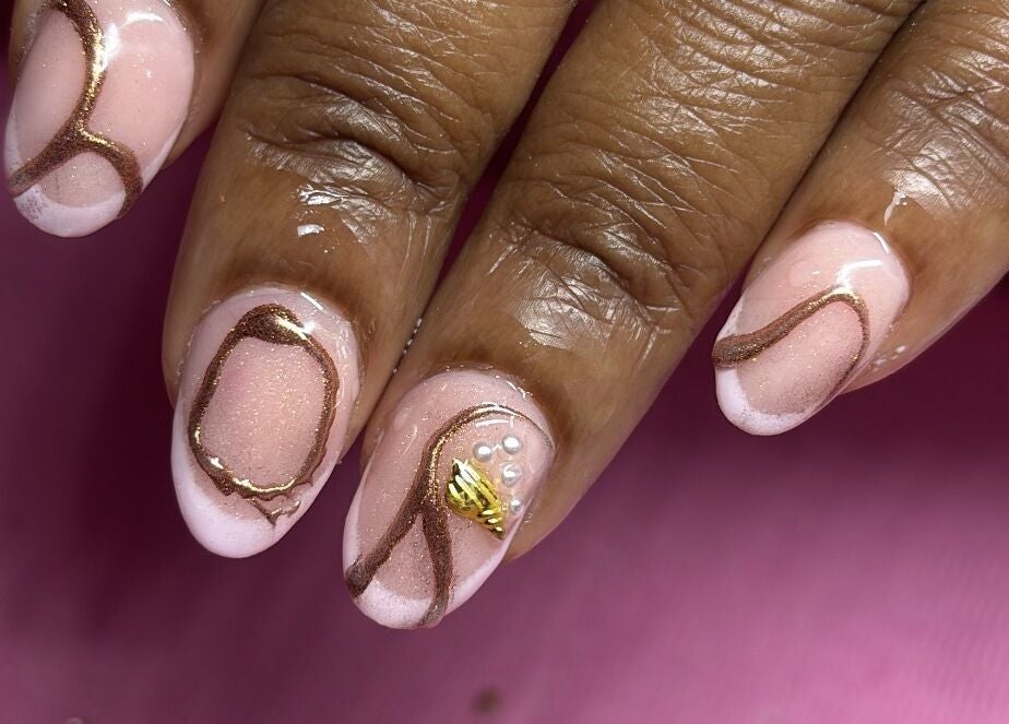 Stylish nail art at SquaredByT, Cole Bay, Sint Maarten, SX showcasing intricate gold and pink designs.