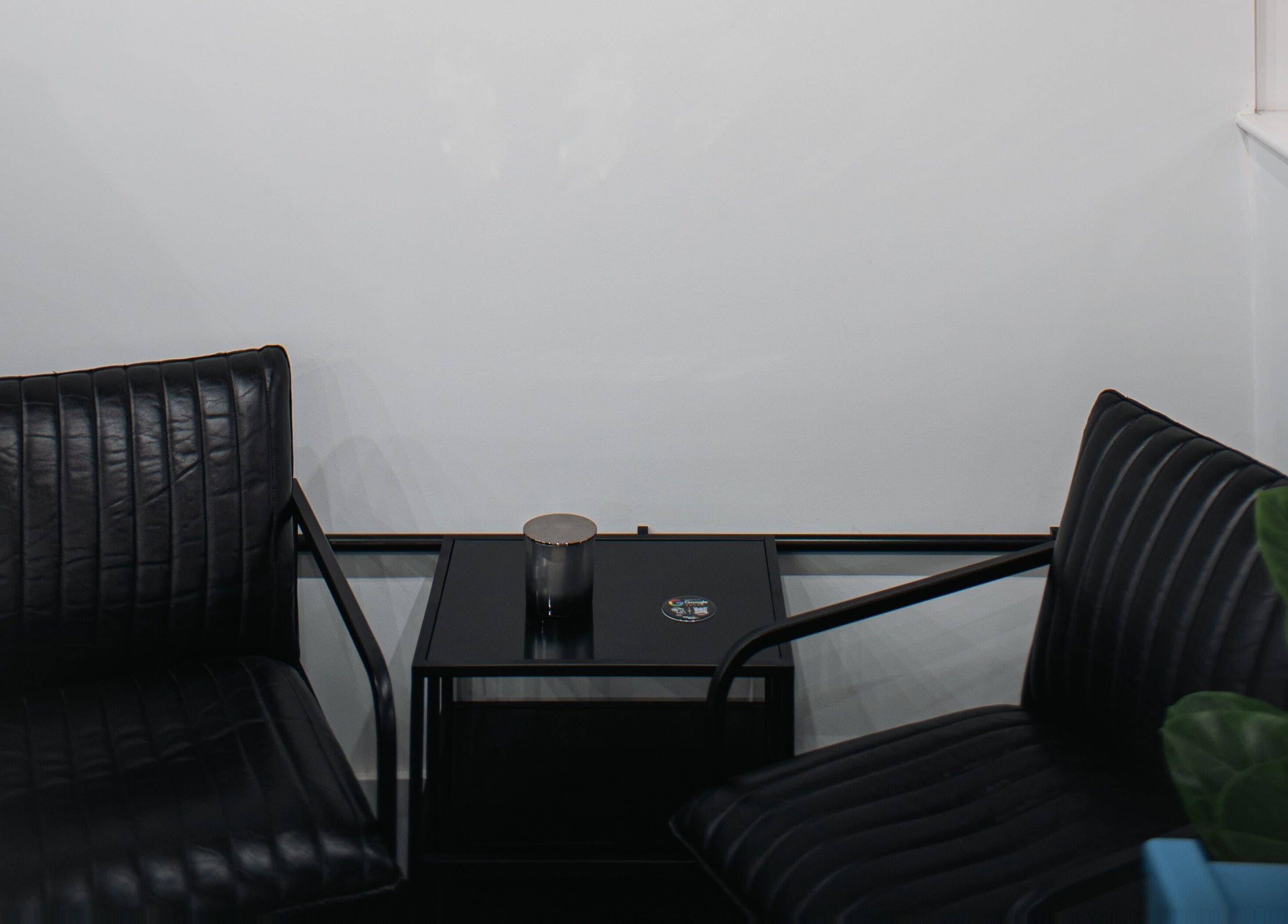 Stylish waiting area with black chairs at ZERO81 Hair Studio - Caledonian Road, London, England, GB.