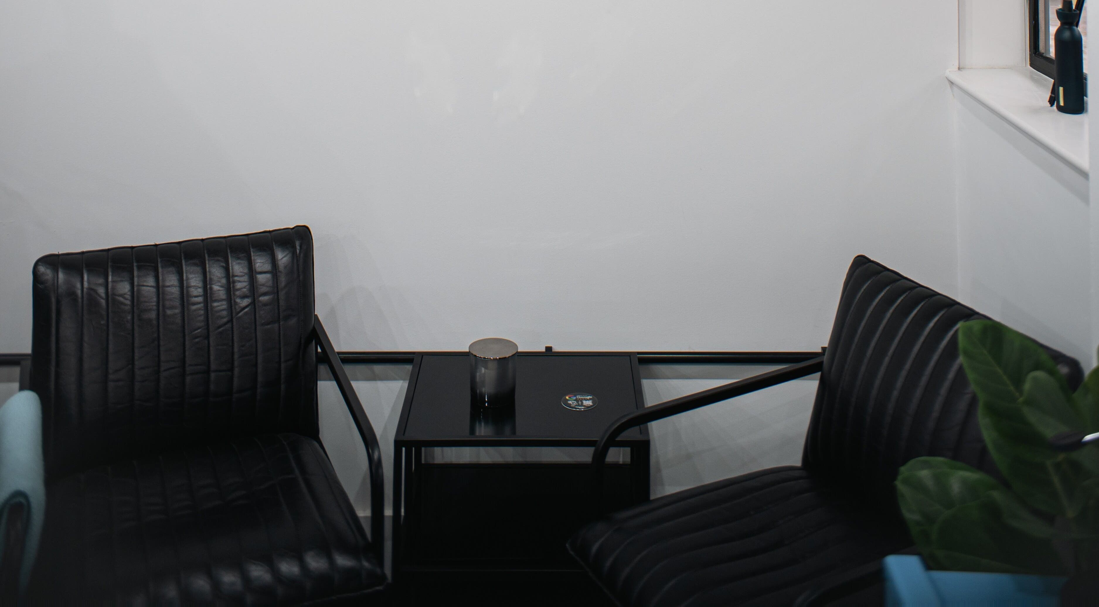 Stylish waiting area with black chairs at ZERO81 Hair Studio - Caledonian Road, London, England, GB.
