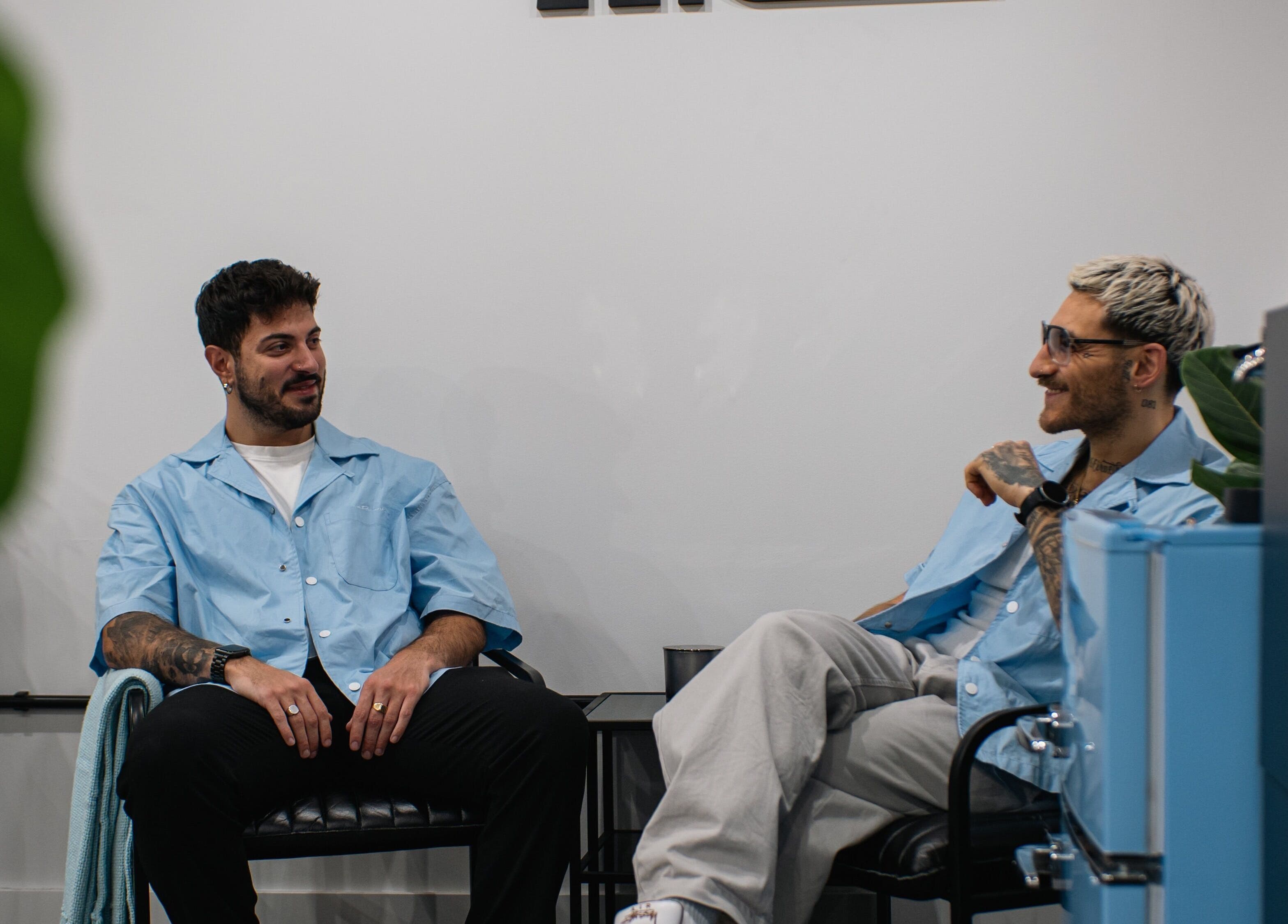Stylish duo chatting in ZERO81 Hair Studio - Caledonian Road, London, England, GB. Modern salon ambiance.