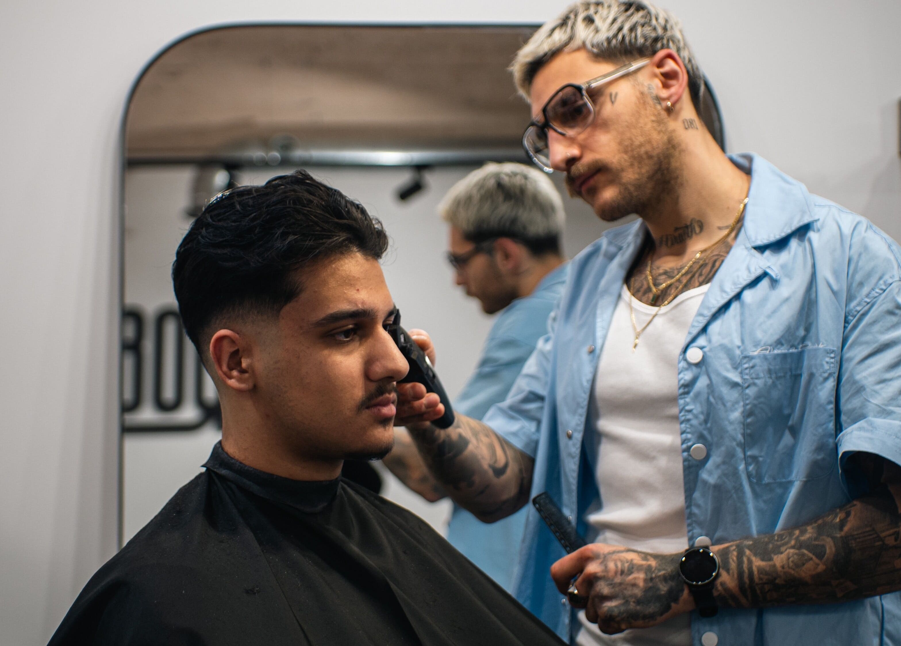 Professional barber at ZERO81 Hair Studio - Caledonian Road in London, England, GB creating a modern haircut.