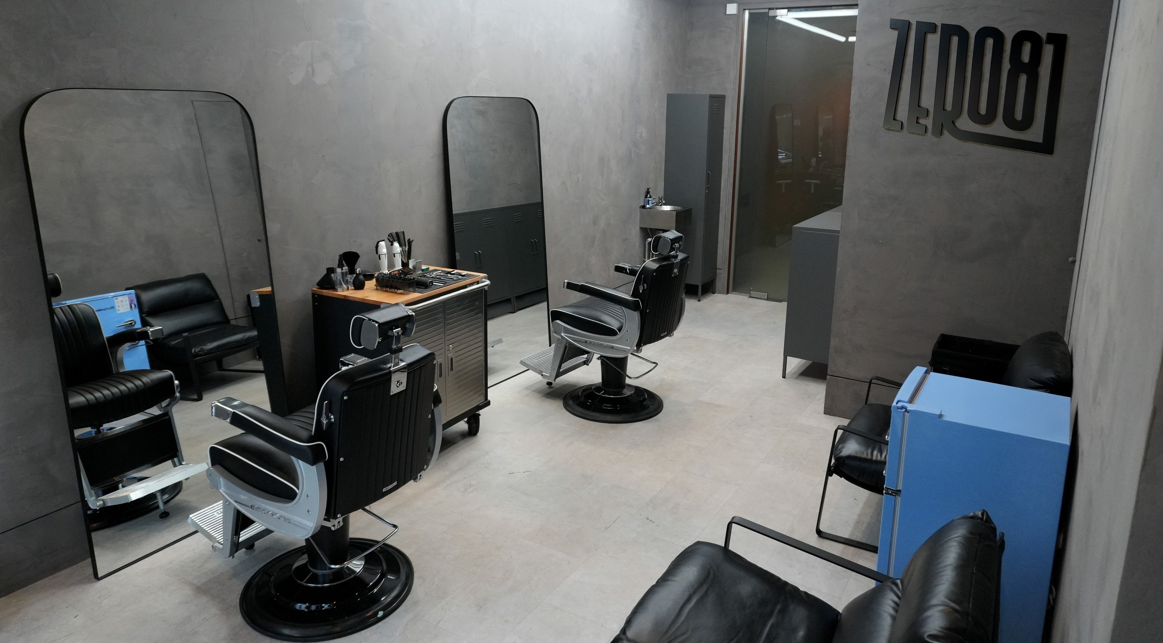 Modern interior of ZERO81 Hair Studio - Liverpool Street in London, England, GB with sleek styling chairs and mirrors.