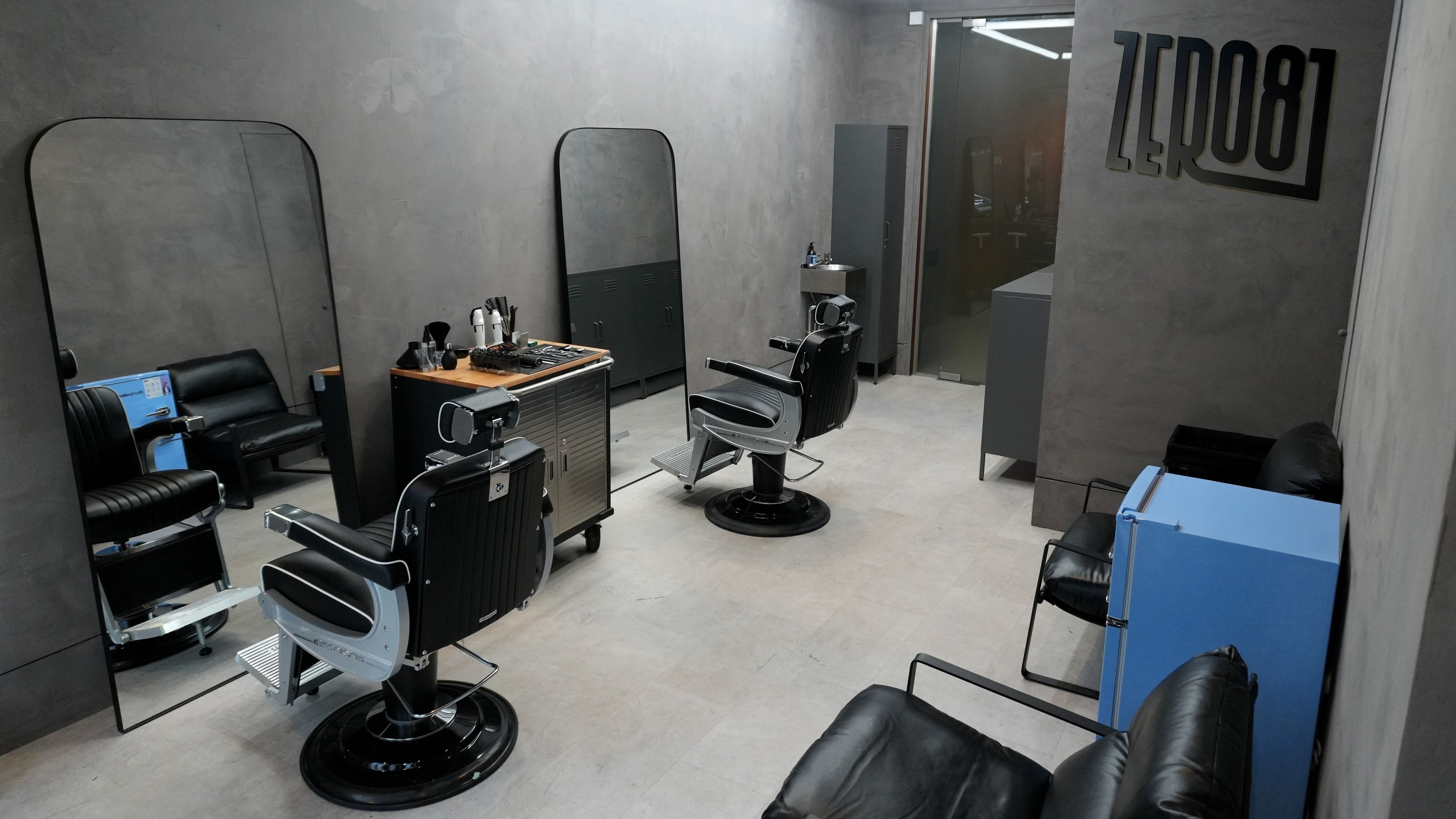 Modern interior of ZERO81 Hair Studio - Liverpool Street in London, England, GB with sleek styling chairs and mirrors.