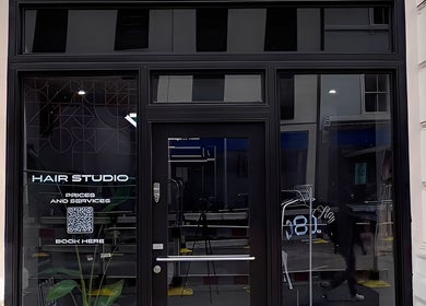ZERO81 Hair Studio - Liverpool Street front entrance, London, England, GB, showcasing modern door and signage.