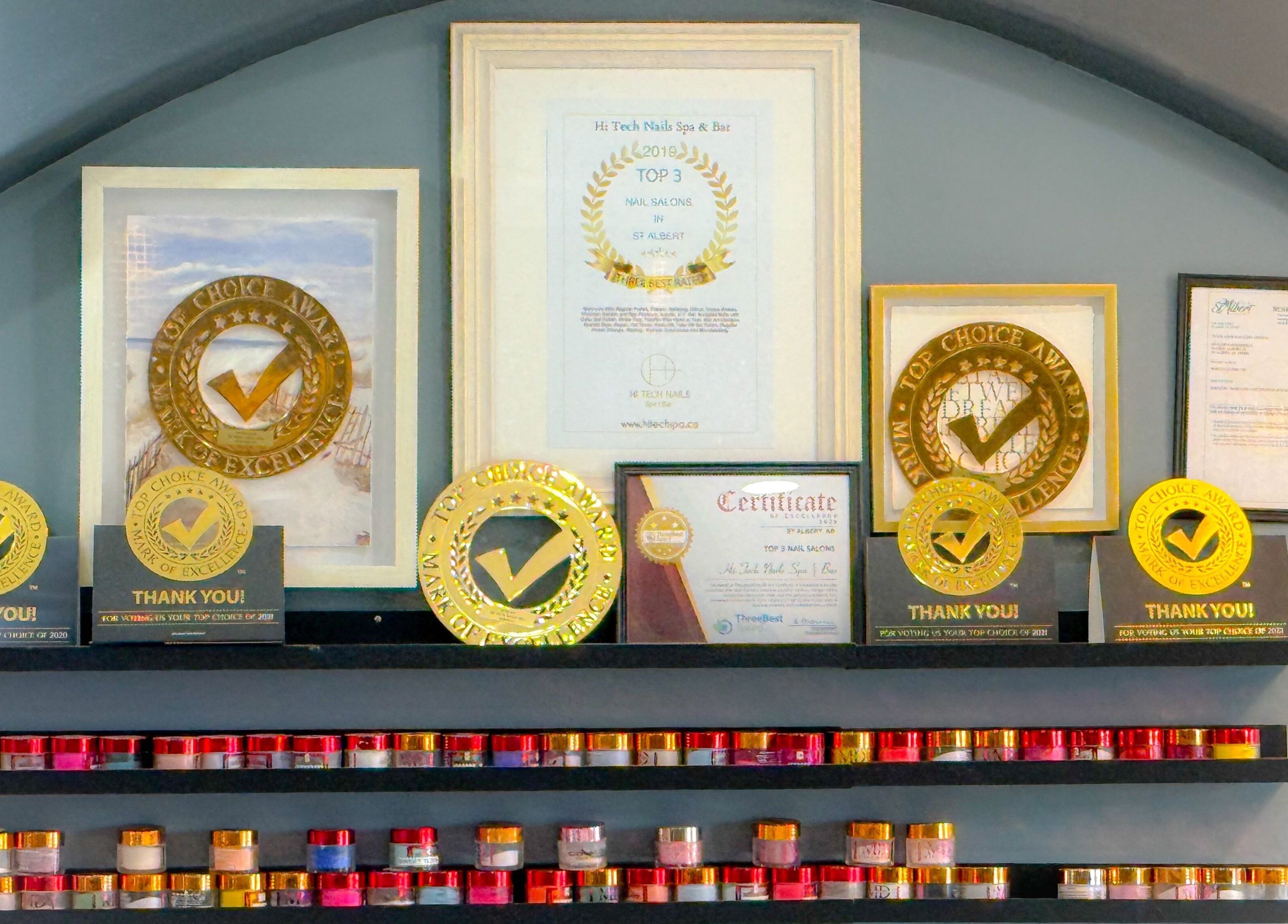 Awards display at Hi-Tech Nails & Spa, St. Albert, Alberta, CA, highlighting excellence in nail care services.