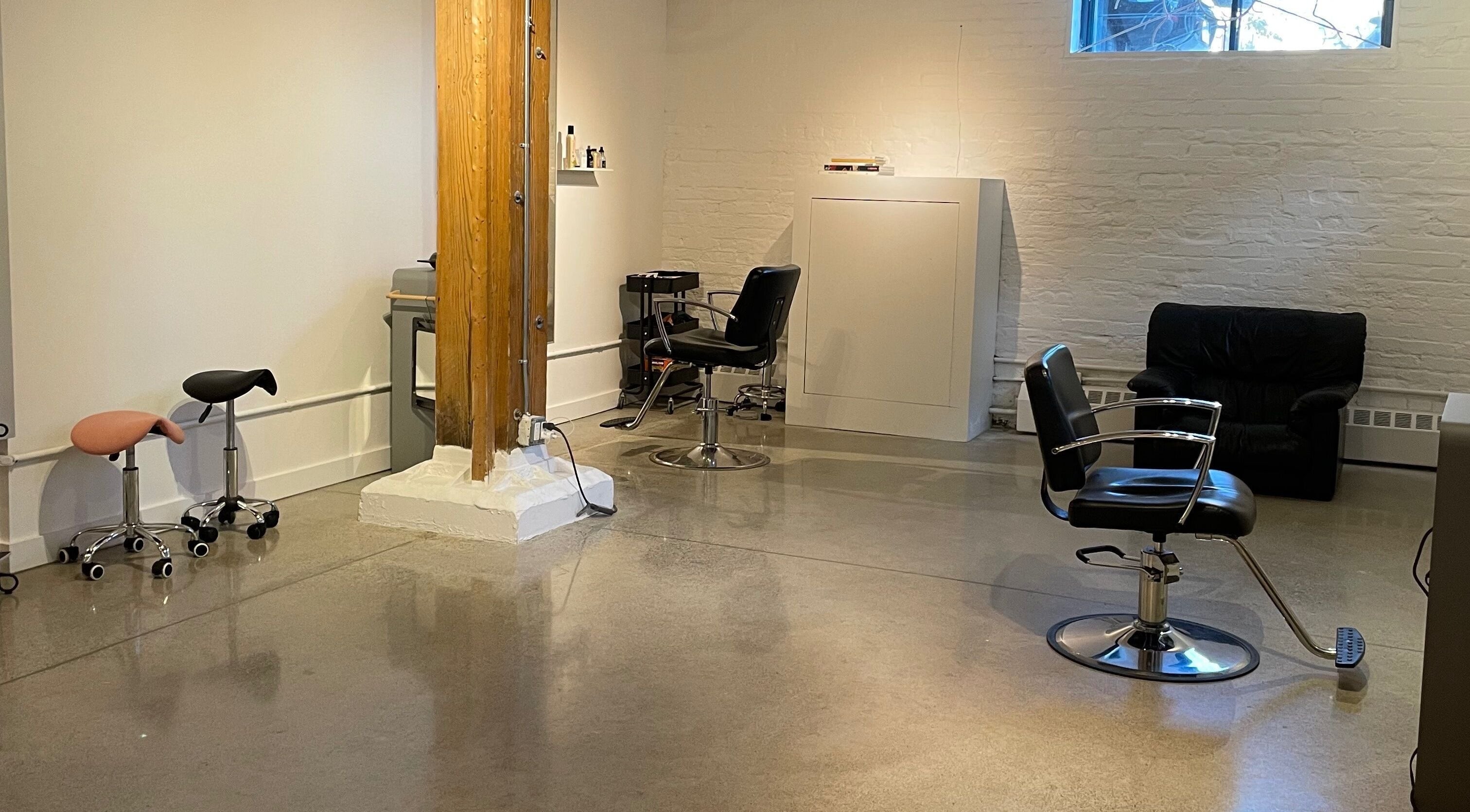 Modern salon interior at Escapa Studios in Toronto, Ontario, CA featuring stylish chairs and sleek design.