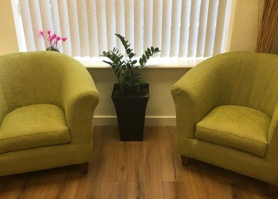Inviting green chairs in the peaceful waiting area of Redditch Therapy Centre, Redditch, England, GB.