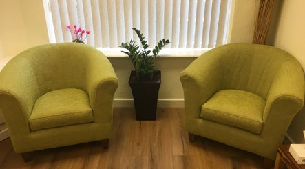 Inviting green chairs in the peaceful waiting area of Redditch Therapy Centre, Redditch, England, GB.