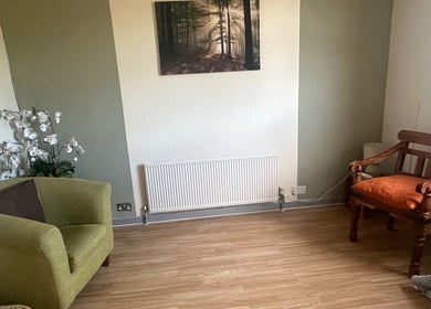 Cozy seating area at Redditch Therapy Centre, Redditch, England, GB with chairs and floral decor.