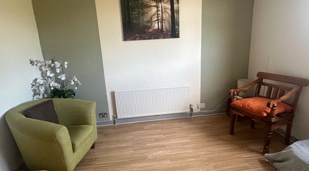 Cozy seating area at Redditch Therapy Centre, Redditch, England, GB with chairs and floral decor.