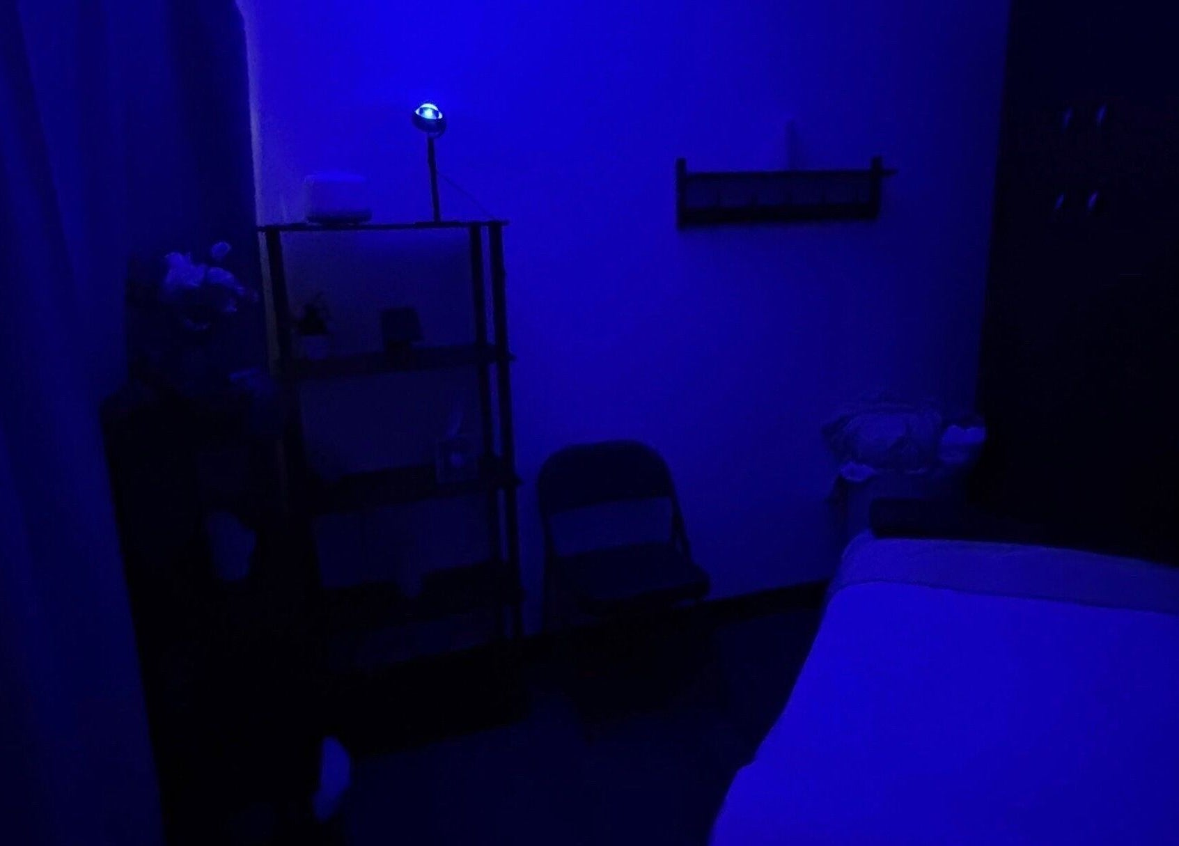 Serene massage room with blue lighting at Moore Magic Massage in North Little Rock, Arkansas, US.