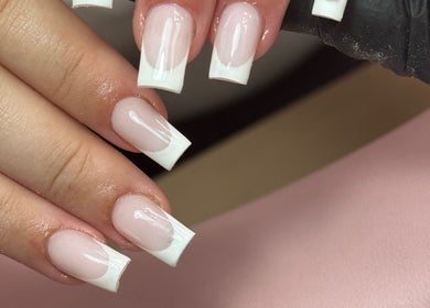 Close-up of fresh French manicure at The Nail Lounge, Barnsley, England, GB showcasing glossy white tips.