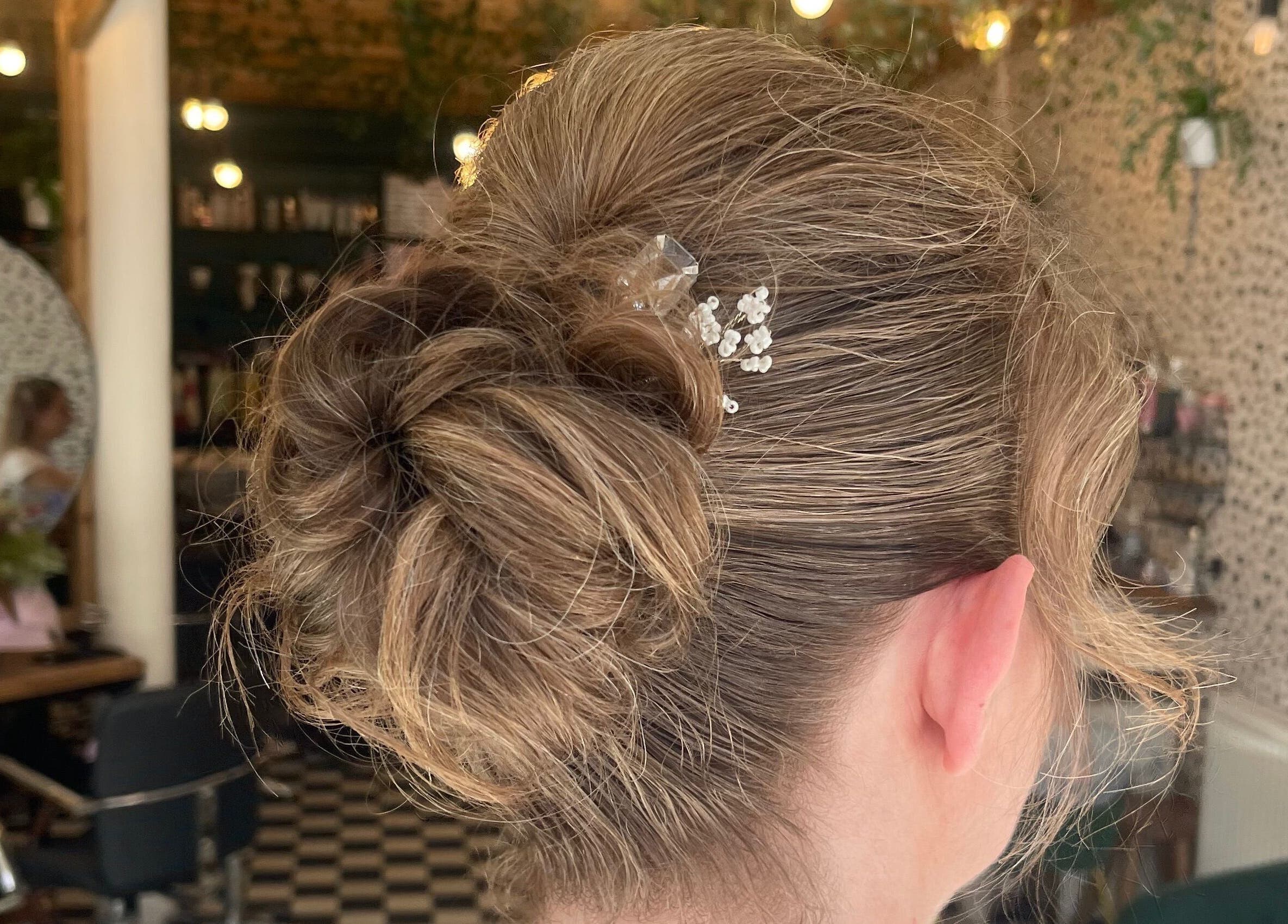 Elegant updo hairstyle with decorative hairpin at Weronika studio, Elgin, Scotland, GB.