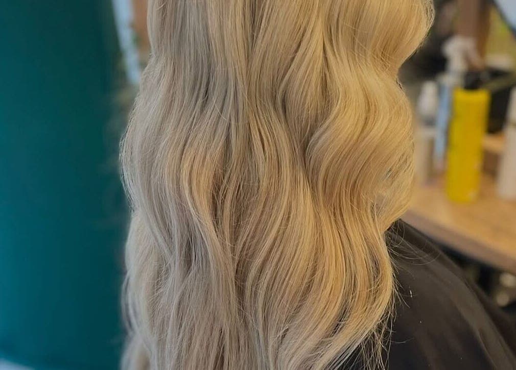 Blonde wavy hairstyle at Weronika studio, Elgin, Scotland, GB, showcasing expert styling.