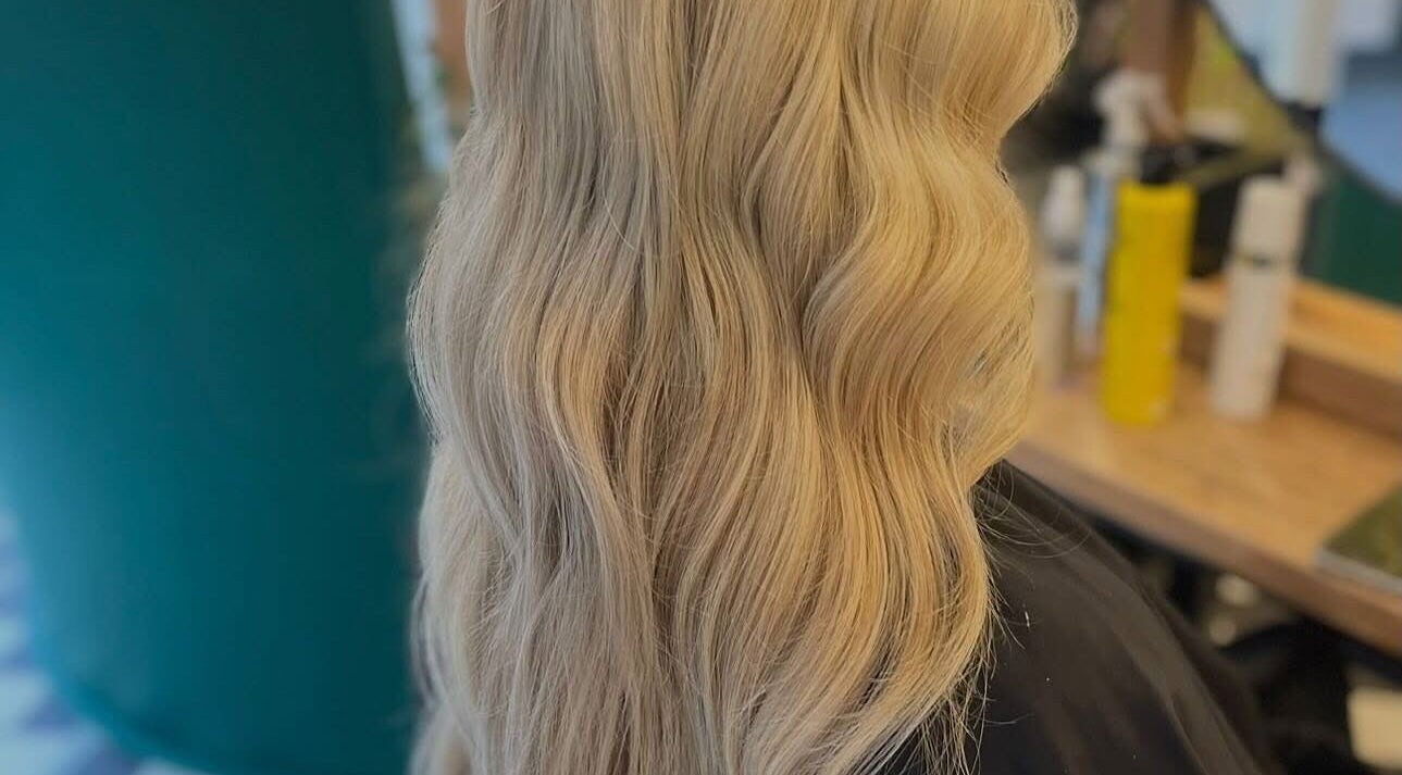 Blonde wavy hairstyle at Weronika Studio, Elgin, Scotland, GB showcasing elegant hair artistry.