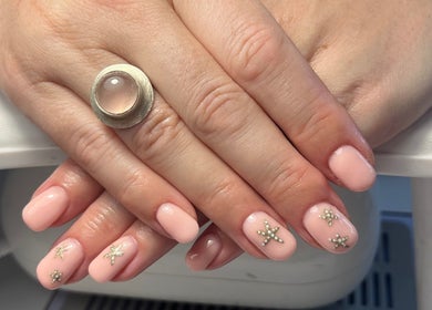 Elegant blush nail design with star accents at The Nail Room, Cliffsend, England, GB.