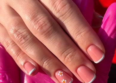 Elegant floral French manicure at The Nail Room, Cliffsend, England, GB, showcasing delicate daisy art.