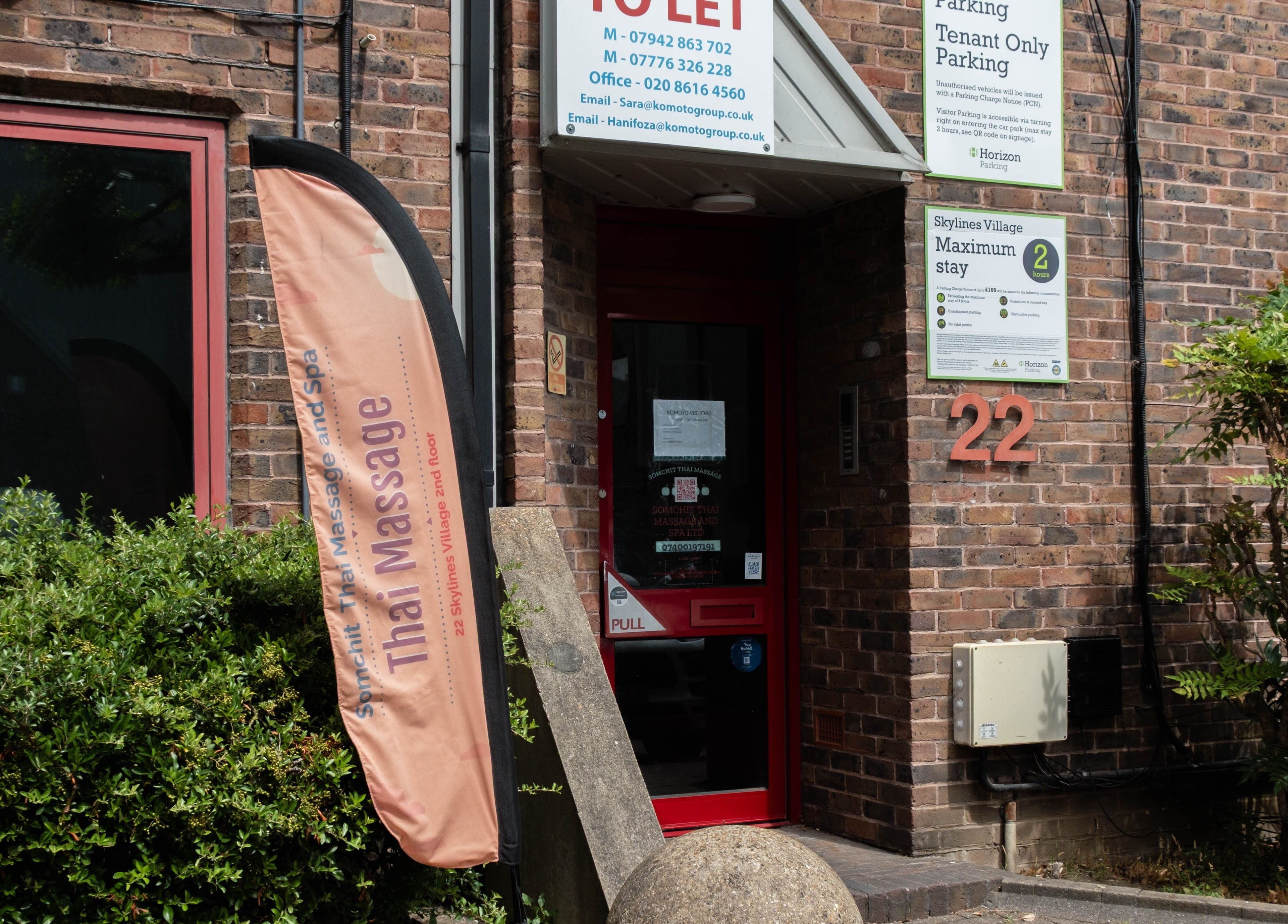 Entrance of Somchit Thai Massage and Spa in London, England, GB, displaying a welcoming sign.