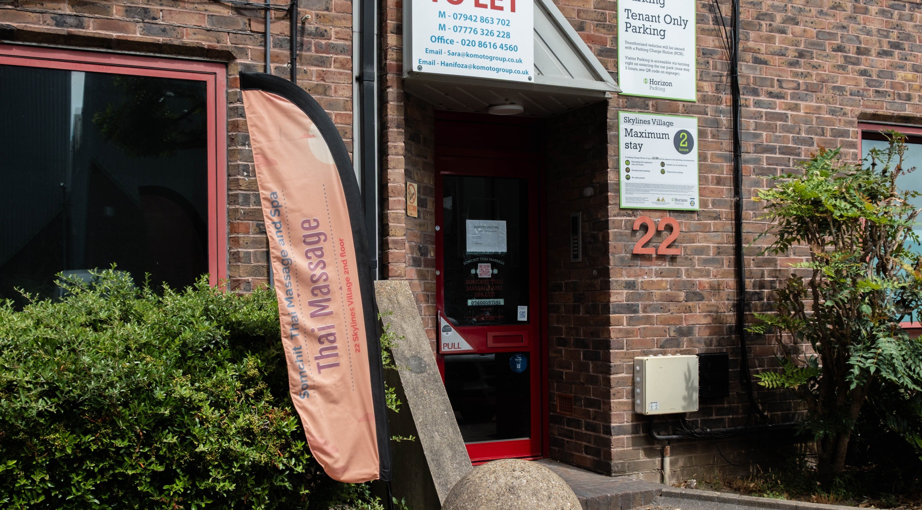 Entrance of Somchit Thai Massage and Spa in London, England, GB, displaying a welcoming sign.