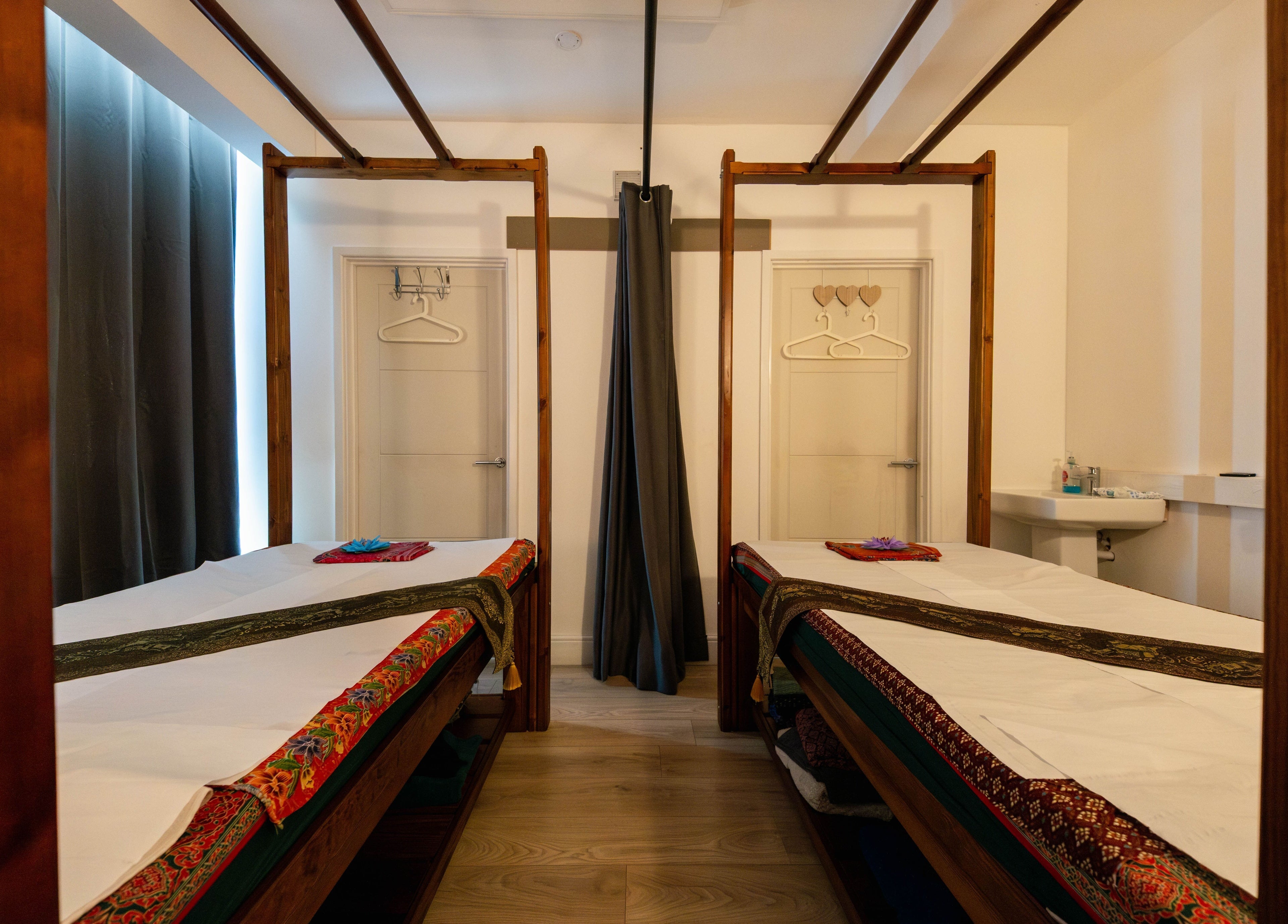 Treatment room at Somchit Thai Massage and Spa in London, England, GB with two massage tables and soft lighting.