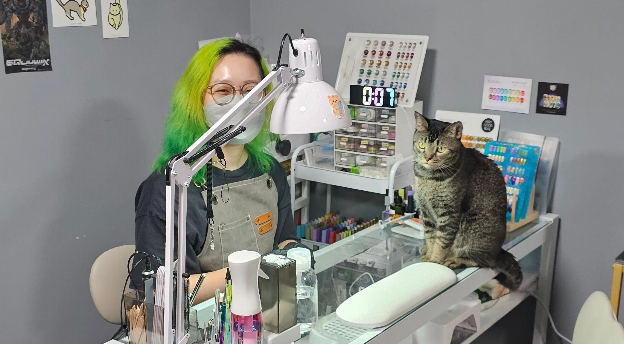 Nail technician and cat at Shady Nail Salon by Alison, Singapore, SG. Cozy and creative nail art space.