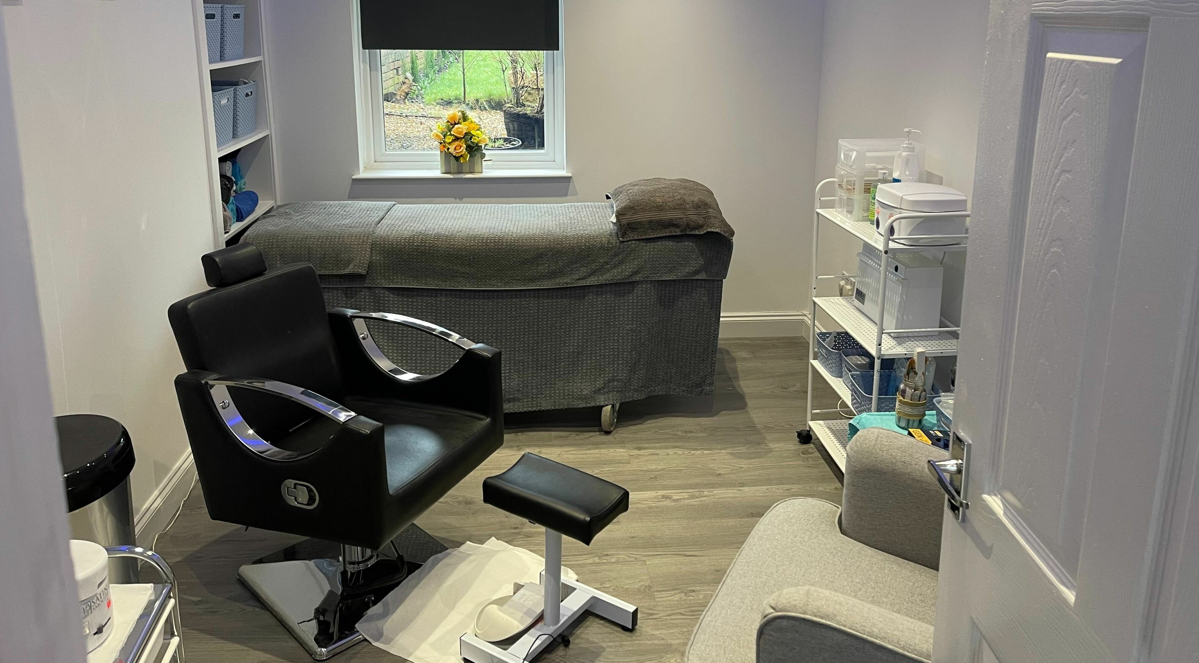 Relaxing therapy room at A Touch of Heaven in Kilbirnie, Scotland, GB with a treatment bed and cozy seating.