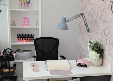 AI Beauty salon in Dingwall, Scotland showcases a chic nail station with floral decor and stylish lamps.
