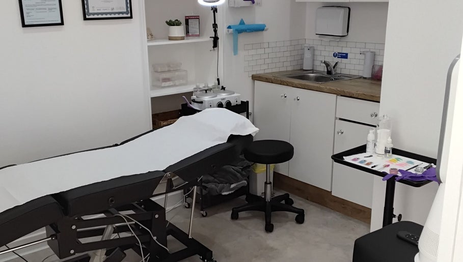 Treatment room at Luxe Lounge, Dingwall, Scotland, GB featuring a comfortable treatment bed and spa equipment.