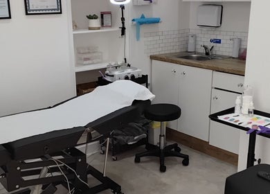 Treatment room at Luxe Lounge, Dingwall, Scotland, GB featuring a comfortable treatment bed and spa equipment.