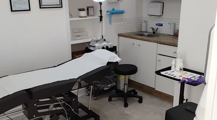 Treatment room at Luxe Lounge, Dingwall, Scotland, GB featuring a comfortable treatment bed and spa equipment.