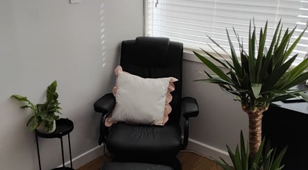 Relaxing corner with chair and plants at Luxe Lounge, Dingwall, Scotland, GB.