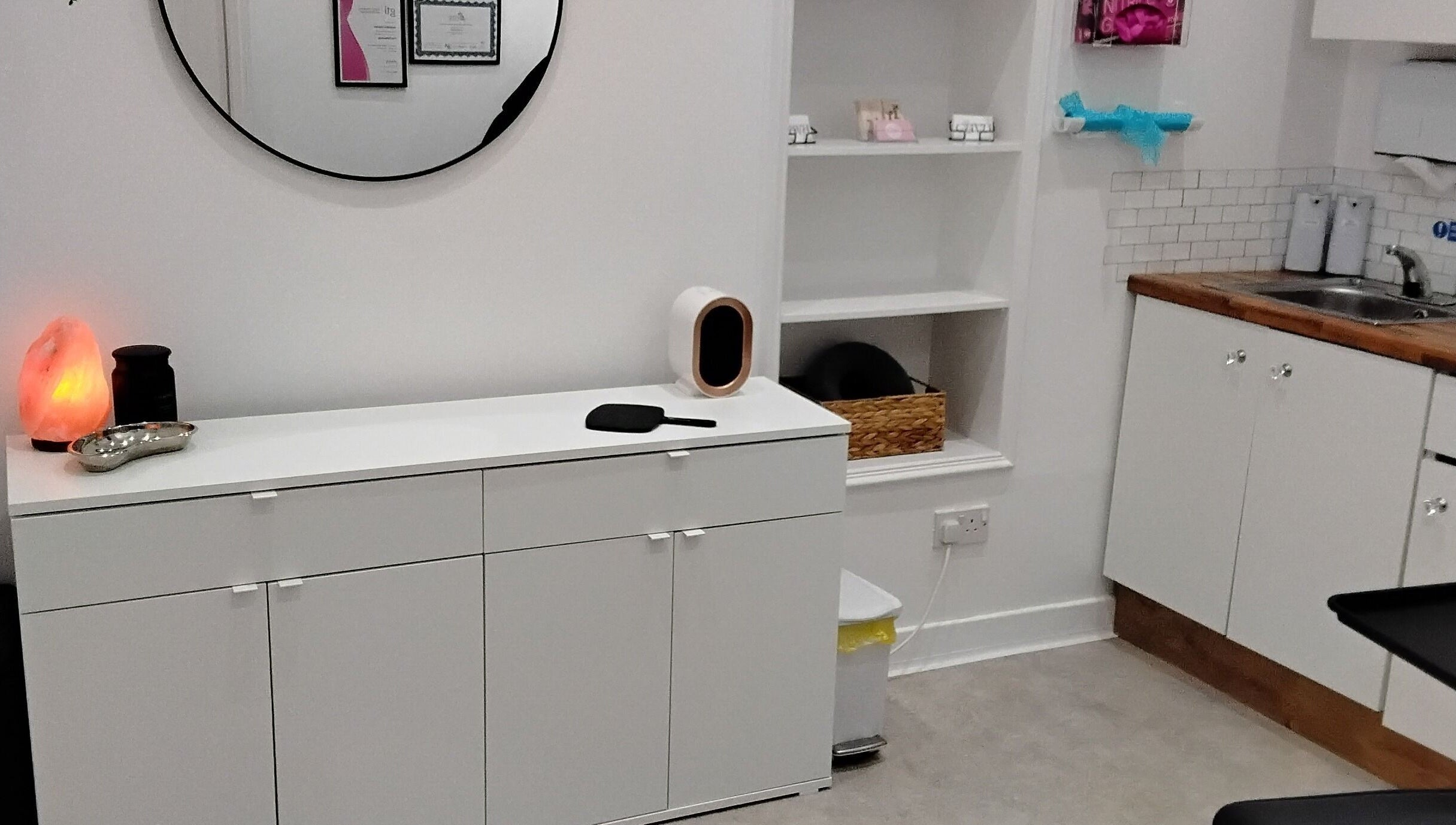 Modern treatment room at Luxe Lounge, Dingwall, Scotland, GB with sleek white cabinets and a salt lamp.