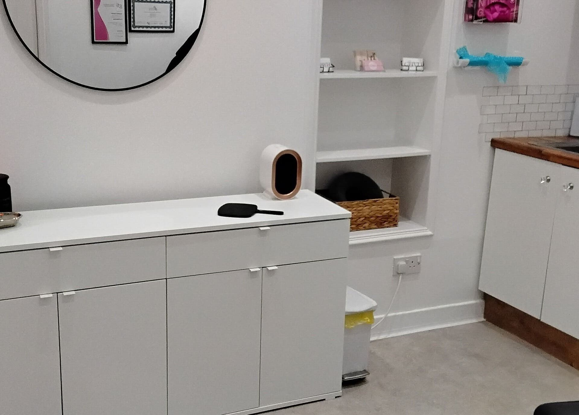 Modern treatment room at Luxe Lounge, Dingwall, Scotland, GB with sleek white cabinets and a salt lamp.