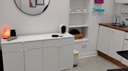 Modern treatment room at Luxe Lounge, Dingwall, Scotland, GB with sleek white cabinets and a salt lamp.