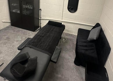 Calming massage room at A.J.Healing, South Ockendon, England, GB with a comfortable black treatment table.
