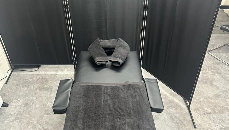 Massage table with black towels at A.J.Healing in South Ockendon, England, GB.