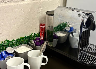 Coffee station at A.J.Healing, South Ockendon, England, GB featuring a sleek espresso machine.