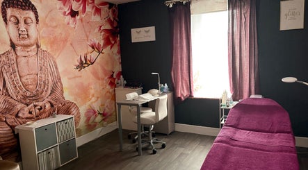 Relaxing treatment room at True Beauty, Forfar, Scotland, GB with Buddha mural and purple accents.