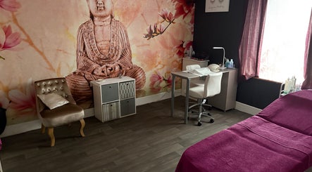 Peaceful treatment room at True Beauty, Forfar, Scotland, GB with a Buddha mural and cozy seating.