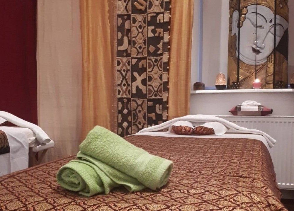 Ruhiger Massageraum bei Hi Spa 1 in Wien, Wien, AT. Entspanntes Ambiente mit Buddha-Dekor und Handtüchern.
