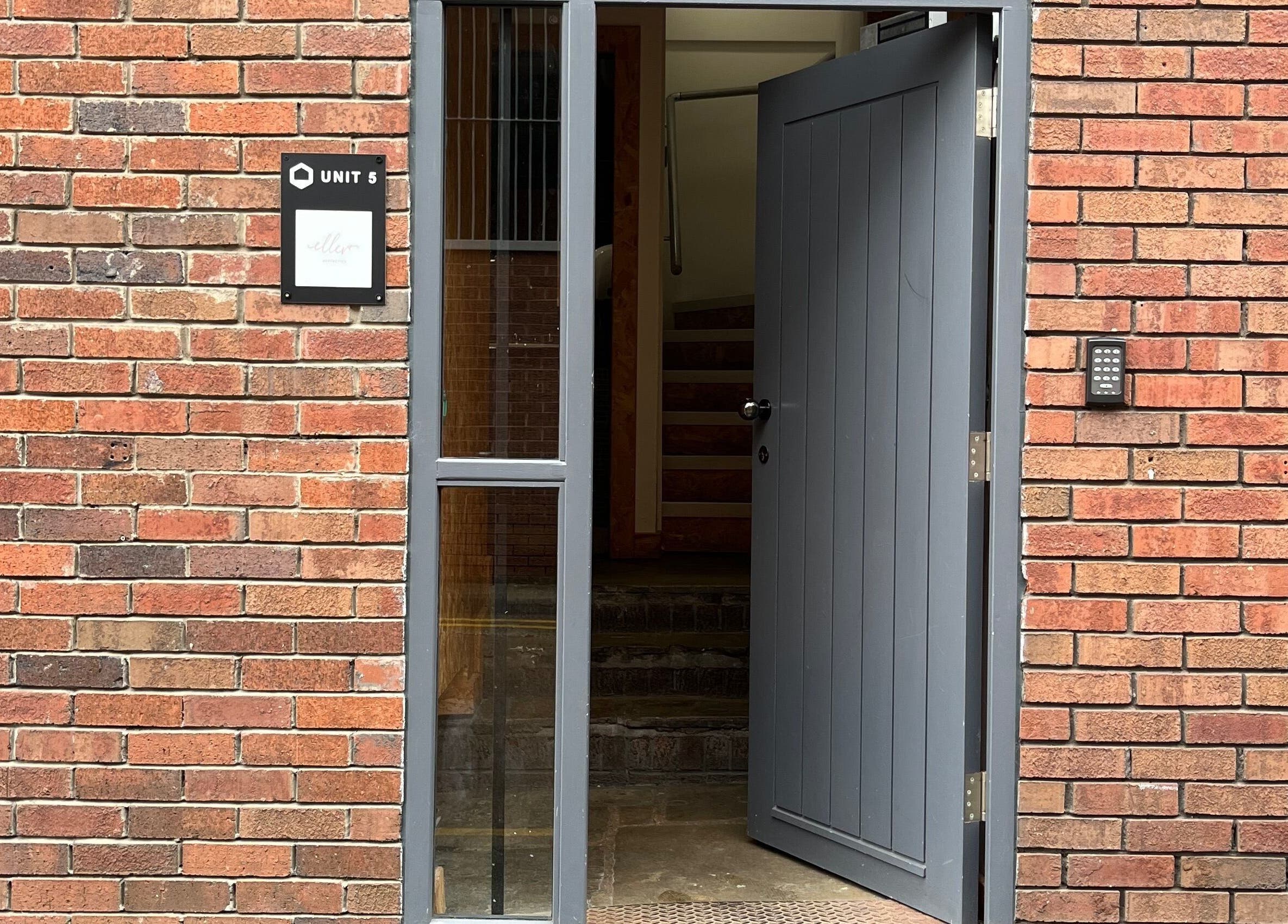 Entrance to Polished by Grace located at Barnsley, England, GB with an open grey door and brick facade.
