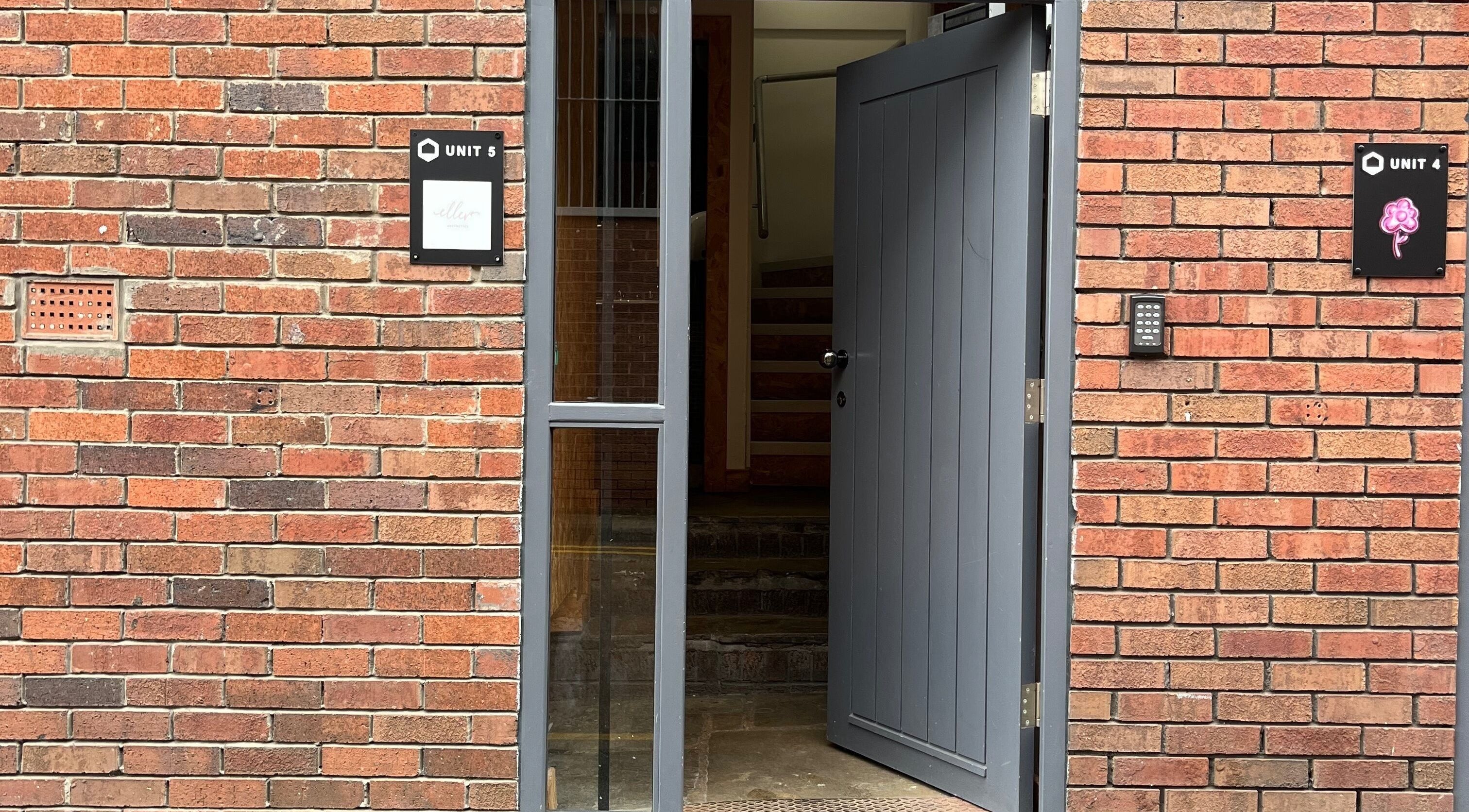 Entrance to Polished by Grace located at Barnsley, England, GB with an open grey door and brick facade.