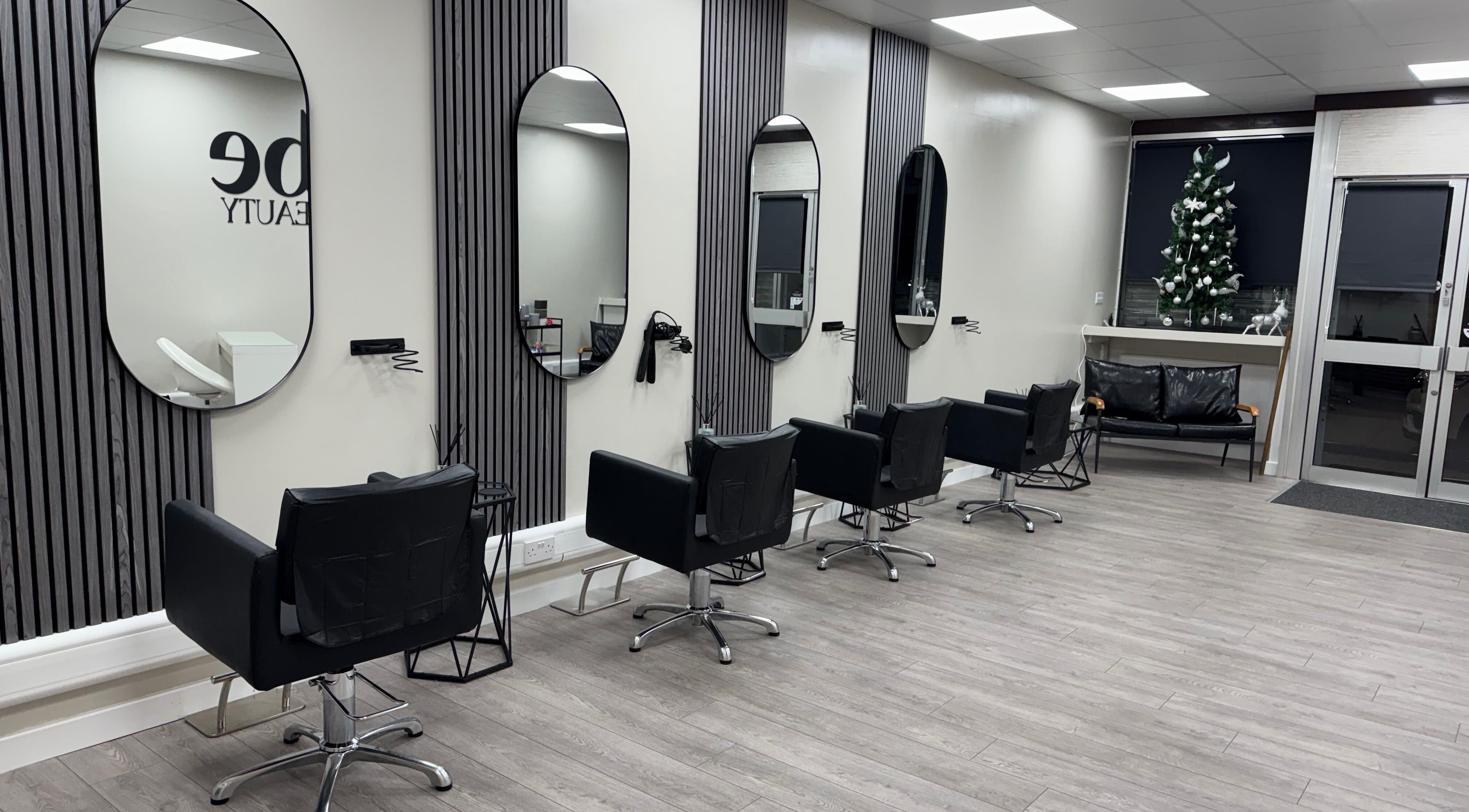 Modern salon interior at Vibe Hair & Beauty, Sunderland, England, GB, showcasing stylish chairs and mirrors.