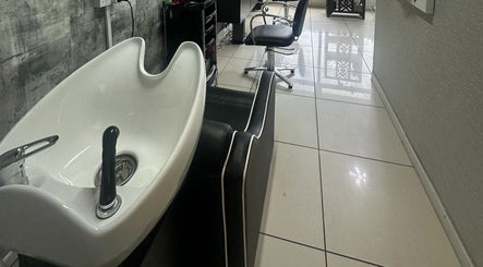 Modern wash station at Siin Hair Beauty in Nottingham, England, GB, with stylish salon chair.
