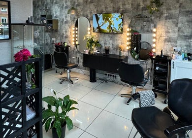 Elegant salon interior at Siin Hair Beauty, Nottingham, England, GB featuring stylish chairs and mirrors.