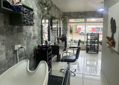 Chic interior of Siin Hair Beauty in Nottingham, England, GB, showcasing modern styling stations and decor.