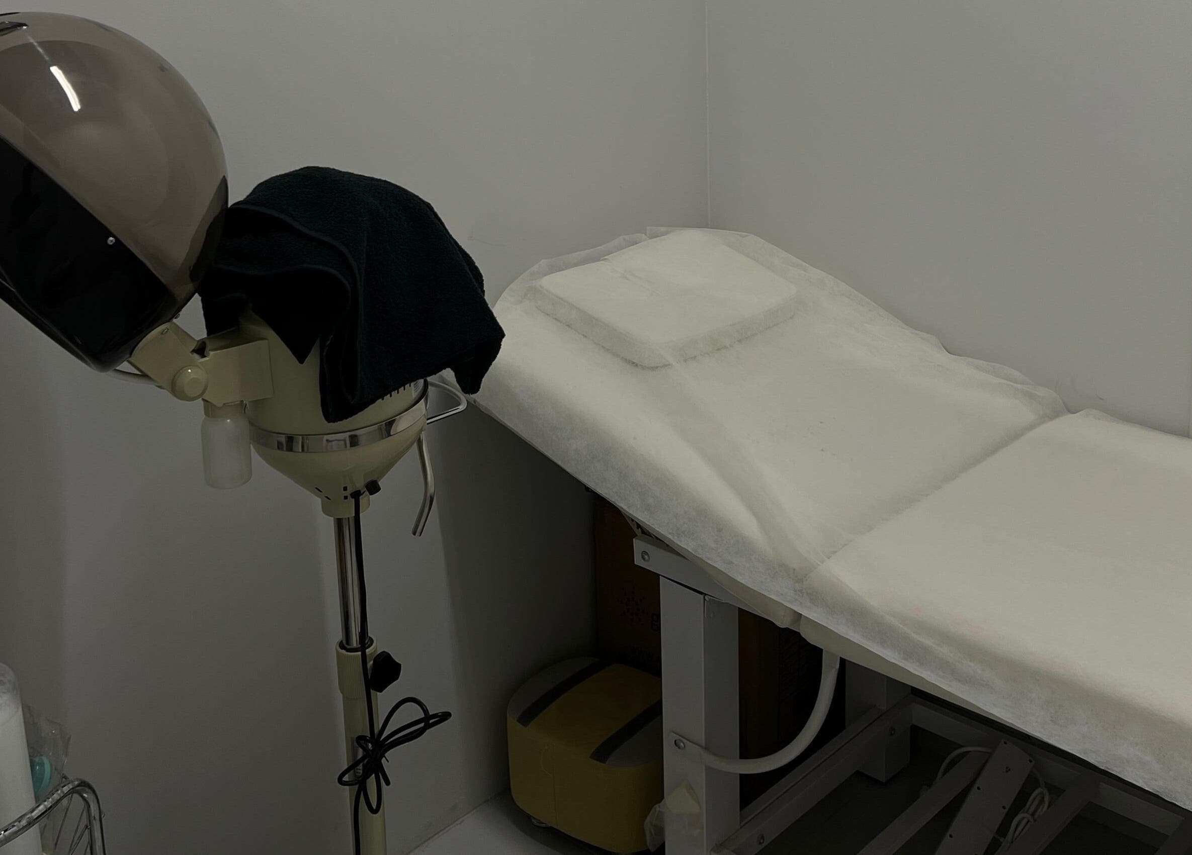 Cozy treatment space at The Barber Lab, Sharjah, Sharjah, AE with massage bed and hair steamer.