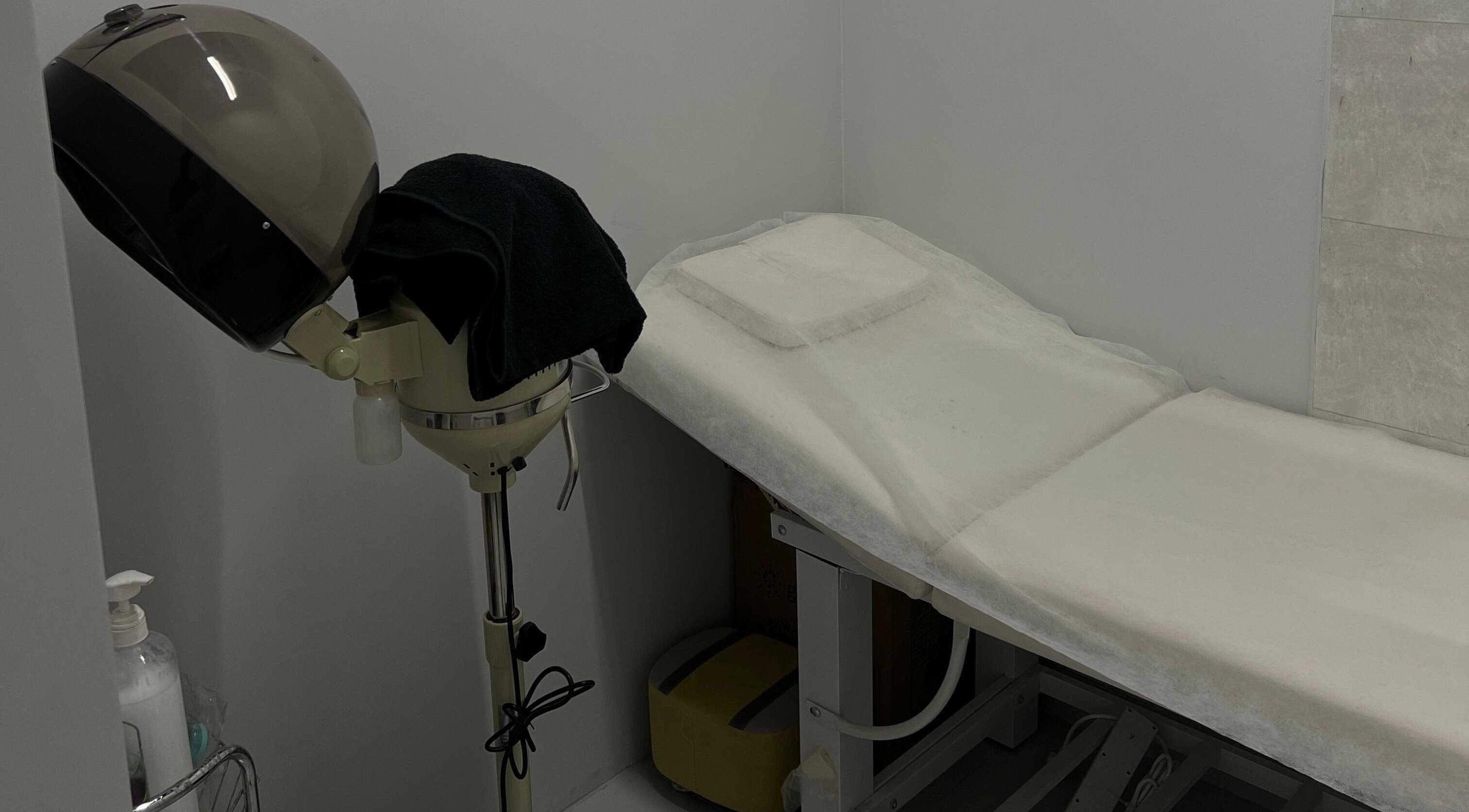 Cozy treatment space at The Barber Lab, Sharjah, Sharjah, AE with massage bed and hair steamer.